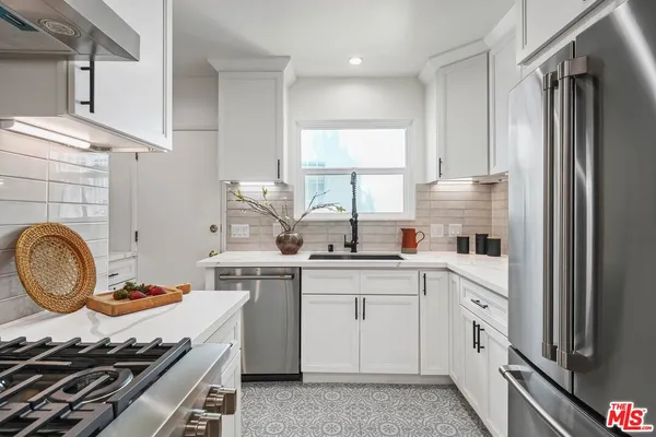 a kitchen with a stove a sink and a refrigerator