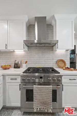 a stove top oven sitting inside of a kitchen
