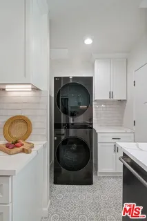 a kitchen with a stove a washer and dryer