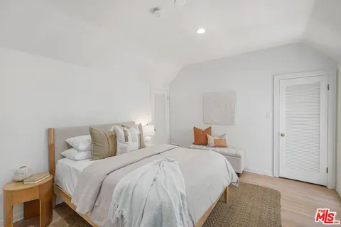 a bedroom with a bed and a lamp