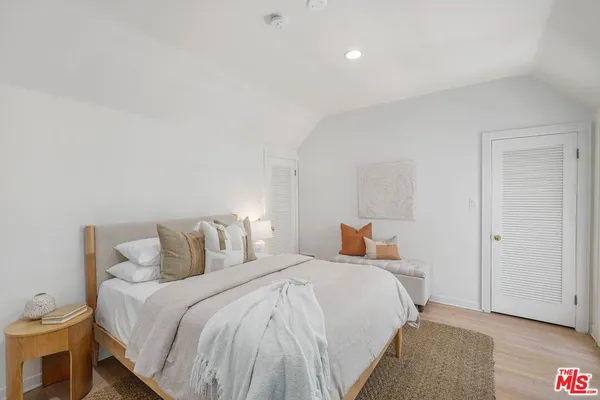 a bedroom with a bed and a lamp