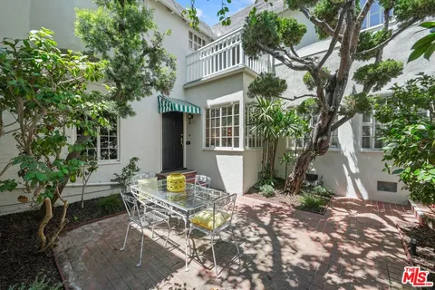 a view of a house with backyard sitting area and garden