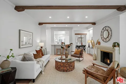 a living room with furniture a clock and a fireplace