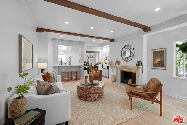 a living room with furniture a clock and a fireplace