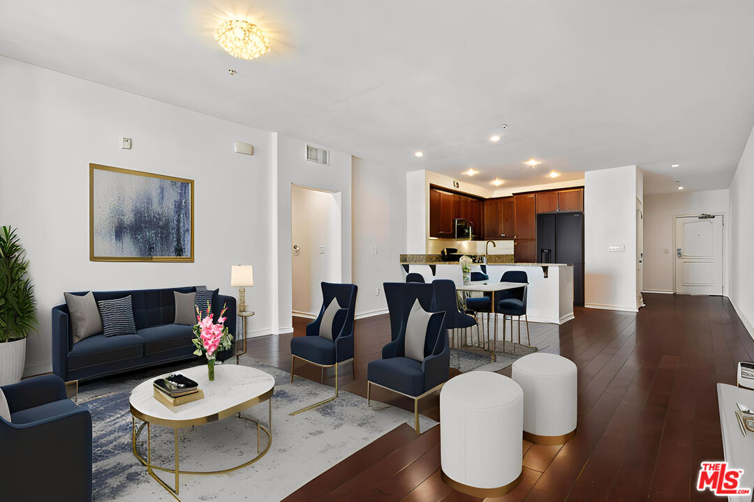 629 Traction Avenue, Unit 507 Los Angeles, CA 90013 - Photo 11 of 52 a living room with furniture and a dining table with wooden floor
