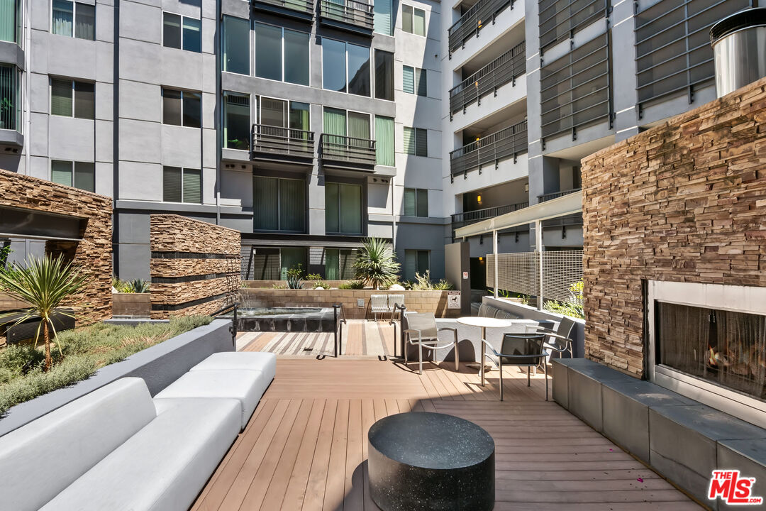 629 Traction Avenue, Unit 507 Los Angeles, CA 90013 - Photo 39 of 52 a view of a patio with couches table and chairs with potted plants