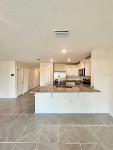 a view of kitchen with refrigerator sink and microwave