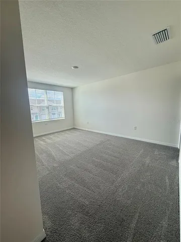 a spacious bathroom with a granite countertop sink toilet and shower