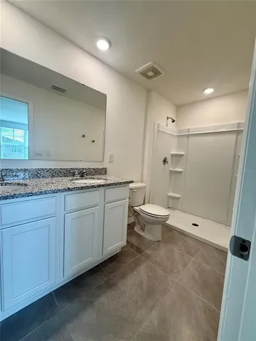 an empty room with mirror and a sink