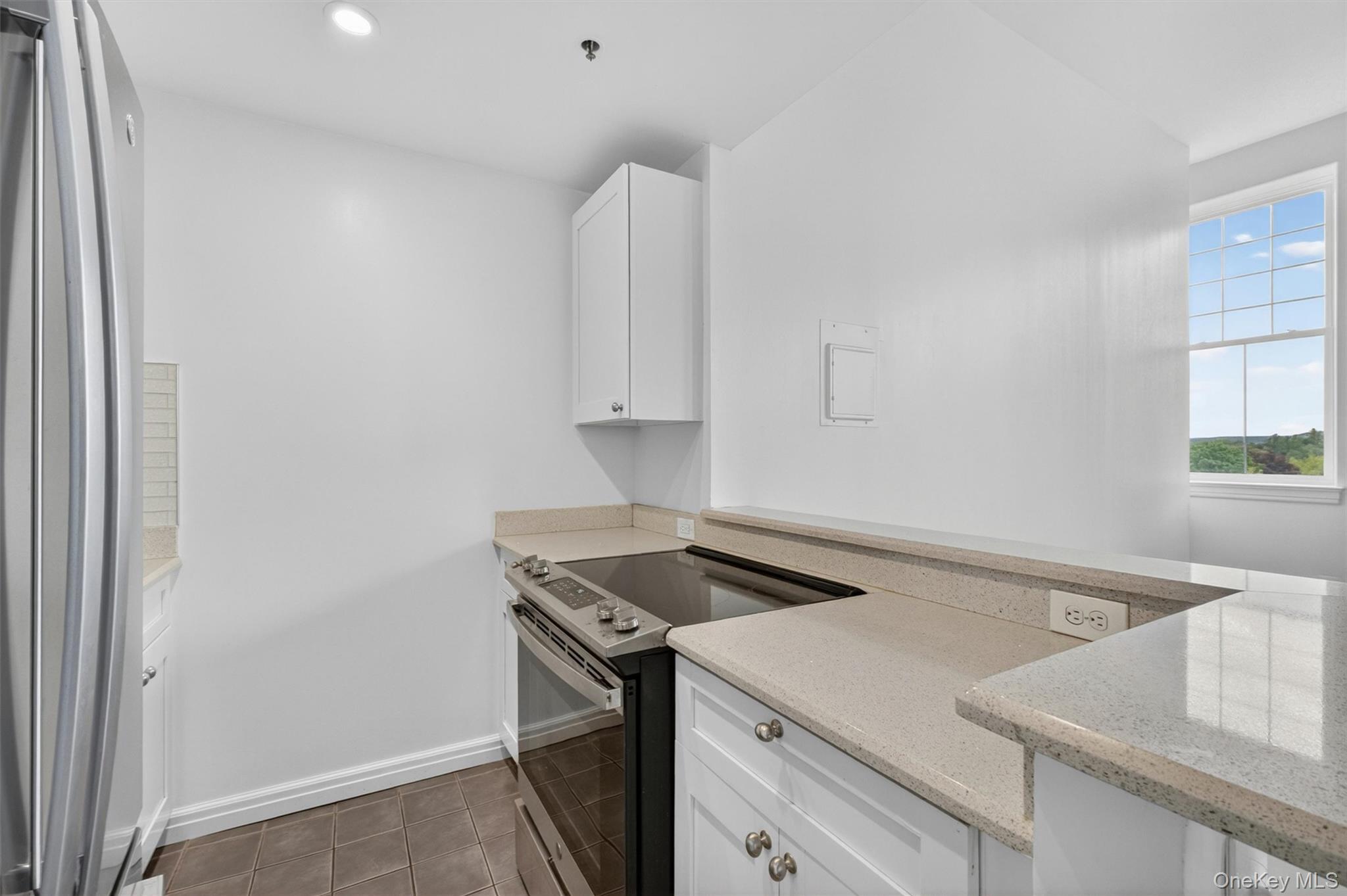 5211 Villa At The Peekskill, NY 10566 - Photo 12 of 19 A view of the beautifully renovated kitchen featuring quartz countertops, stainless steel appliances, and a bright, open feel.
