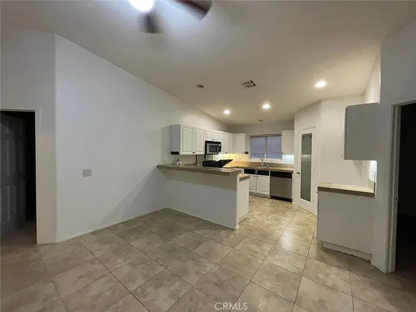 a kitchen with a refrigerator and a counter top space
