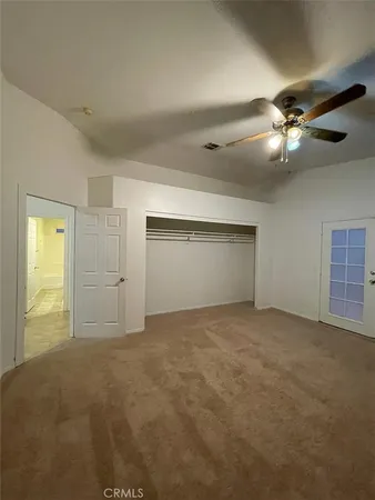 a view of empty room with a ceiling fan