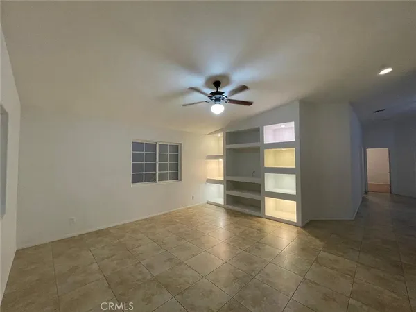 an empty room with closet and windows
