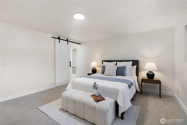 a bedroom with bed and a night stand