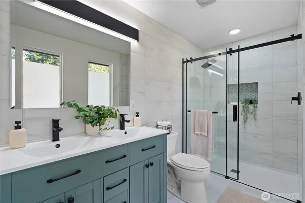 a bathroom with a sink toilet and shower