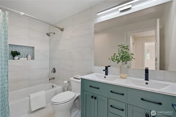 a bathroom with a double vanity sink toilet and shower