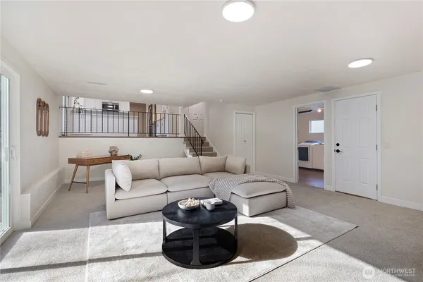 a living room with furniture and a wooden floor