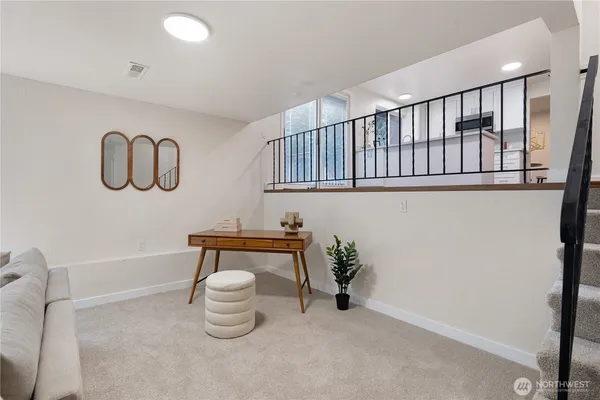 a living room with furniture and a potted plant