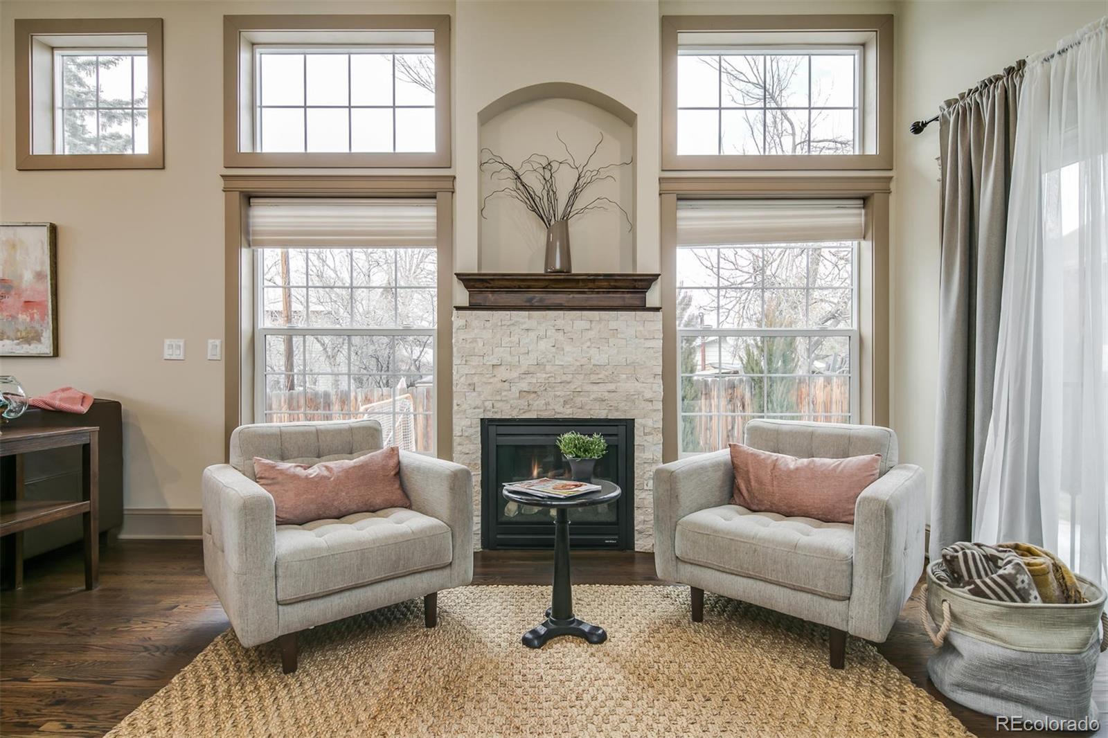 515 East Iliff Avenue Denver, CO 80210 - Photo 13 of 35 a living room with furniture and a fireplace