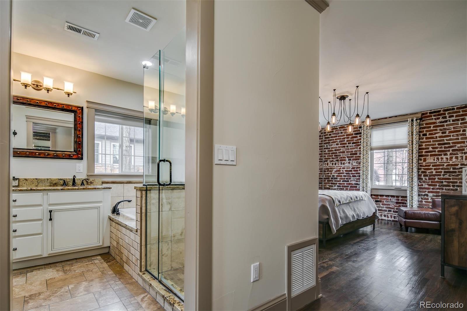 515 East Iliff Avenue Denver, CO 80210 - Photo 17 of 35 a en suite bathroom with a granite countertop sink and a mirror