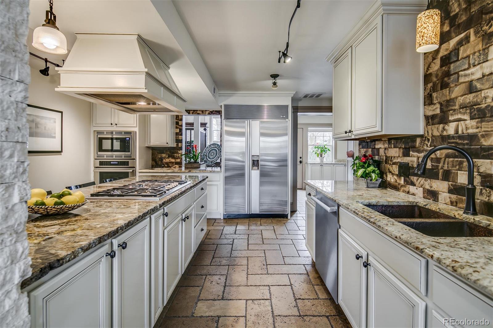 515 East Iliff Avenue Denver, CO 80210 - Photo 10 of 35 a kitchen with stainless steel appliances granite countertop a sink stove and refrigerator