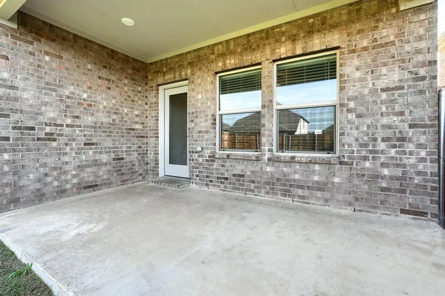 a view of a brick house with a large window