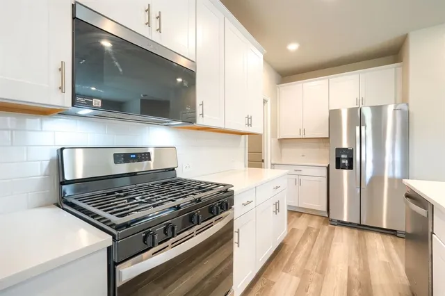 a kitchen with a stove a sink and a refrigerator