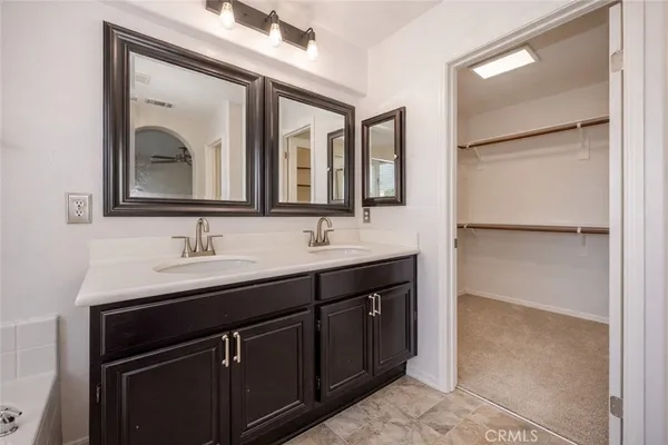 a bathroom with 2 sink and a mirror