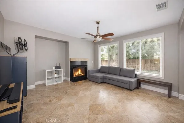 a living room with furniture and a fireplace