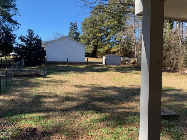a backyard of a house with yard and outdoor seating