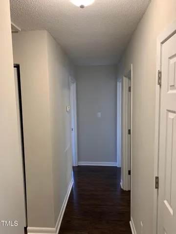 a view of hallway with wooden floor