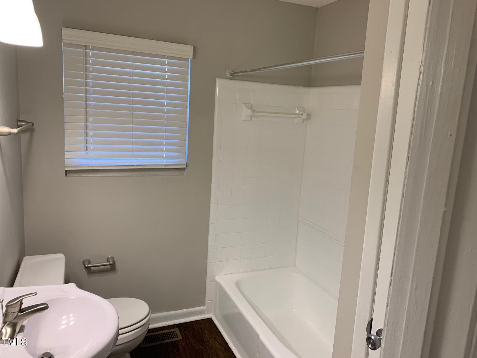 3604 Bowling Drive Raleigh, NC 27606 - Photo 8 of 10 a bathroom with a sink and a toilet