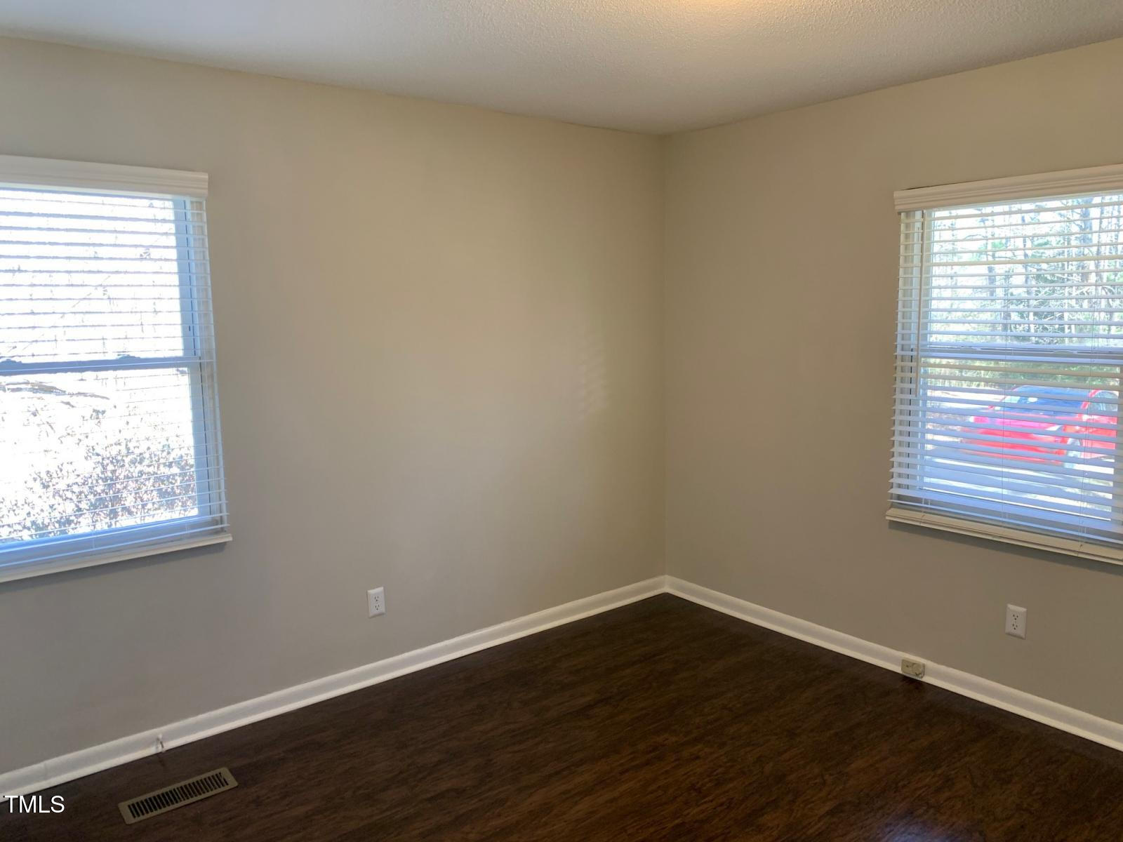 3604 Bowling Drive Raleigh, NC 27606 - Photo 9 of 10 an empty room with wooden floor and windows
