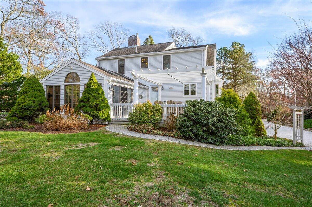 a front view of a house with a garden