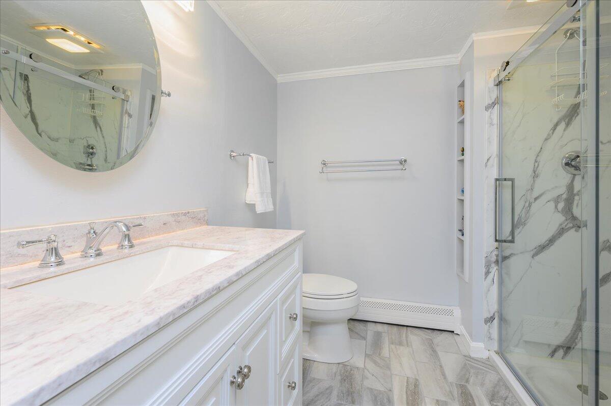 4 Faunce Mountain Road Sandwich, MA 02563 - Photo 21 of 32 a bathroom with a granite countertop sink a toilet and a mirror