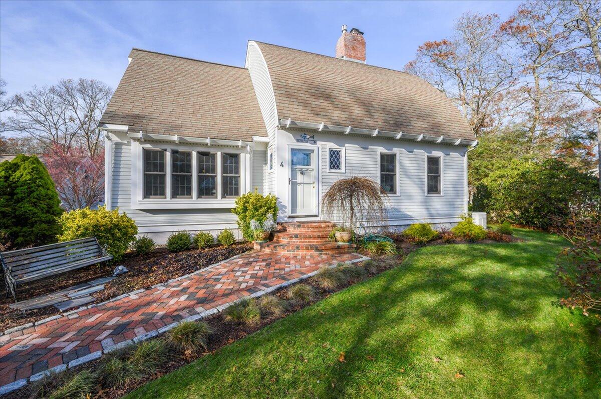 4 Faunce Mountain Road Sandwich, MA 02563 - Photo 30 of 32 a front view of house with yard and outdoor seating