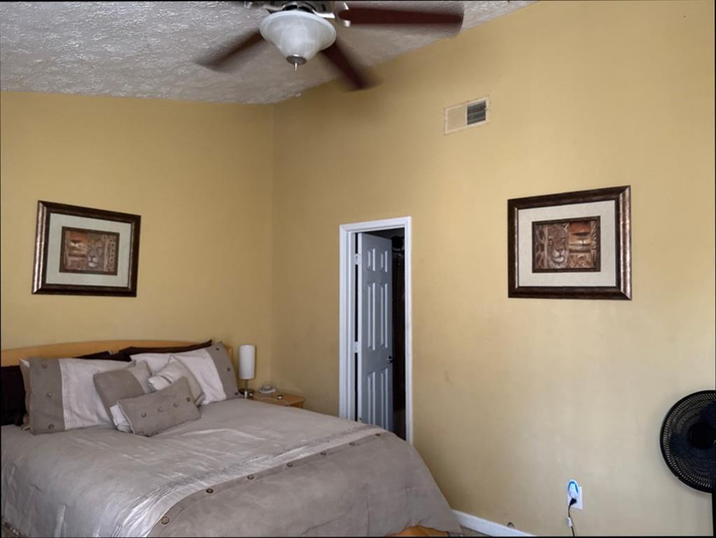 3994 Elm Street Atlanta, GA 30341 - Photo 9 of 15 a bedroom with a bed and a painting on the wall