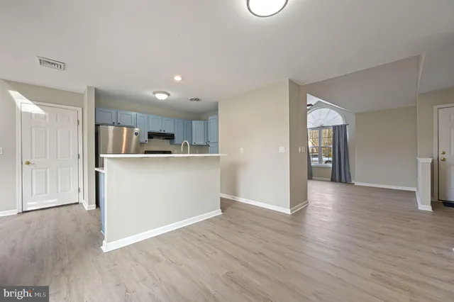 a view of a kitchen with wooden floor