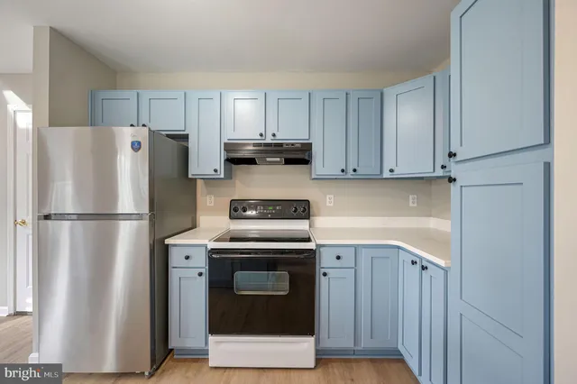 a kitchen with stainless steel appliances granite countertop a refrigerator a stove a sink and a refrigerator