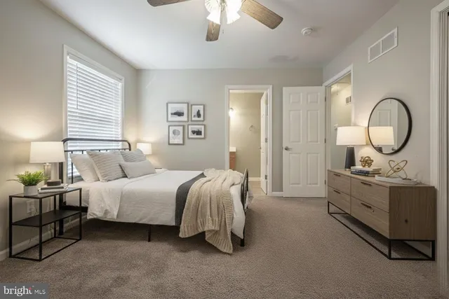 a bedroom with bed and a chandelier