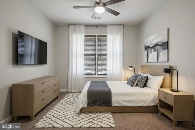 a bedroom with a bed and a flat screen tv
