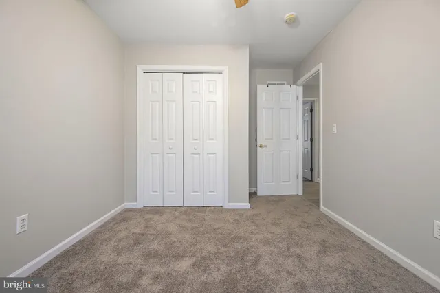 an empty room with closet area