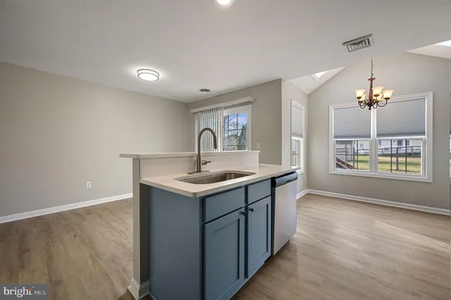 a kitchen with a sink and chandelier