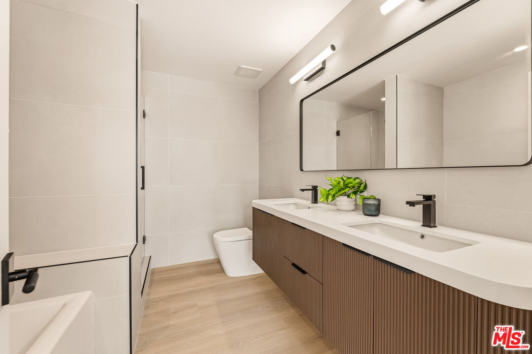 311 Bora Bora Way, Unit 3207 Marina del Rey, CA 90292 - Photo 27 of 54 a bathroom with a sink and a mirror
