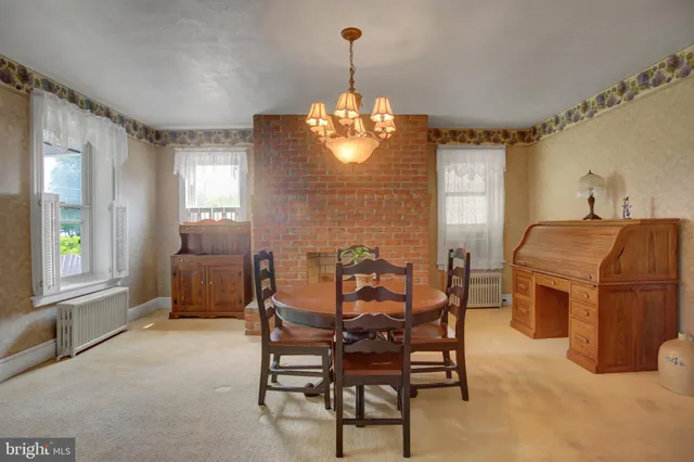 a dining room with furniture and window