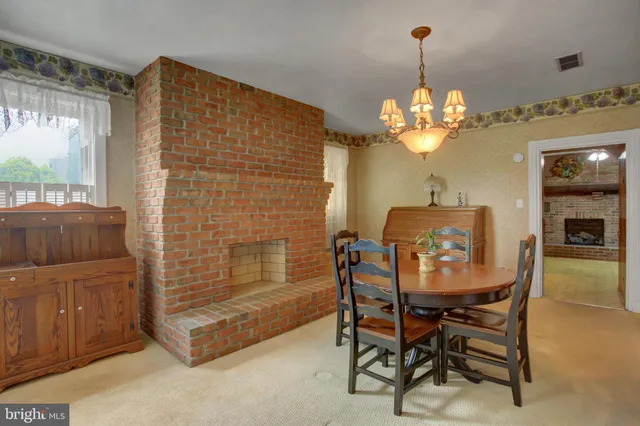 a view of a livingroom with a fireplace and a hallway