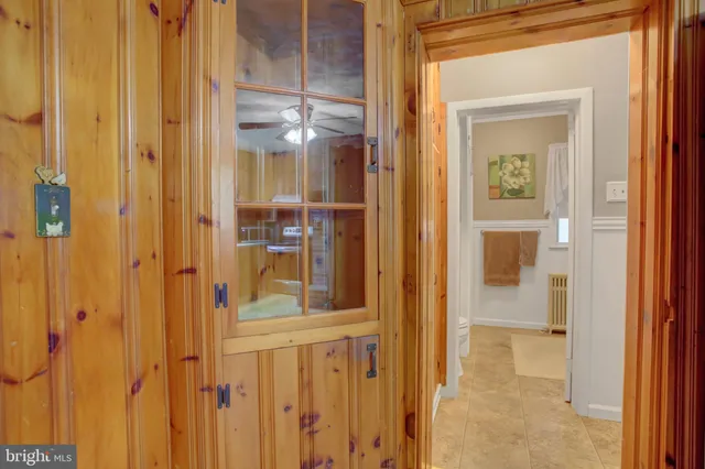 a hallway with a wooden floor and a cabinet