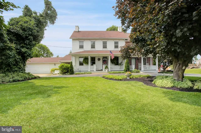a front view of a house with a yard table and chairs