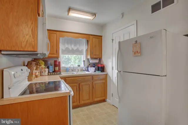 a view of a patio with table and chairs potted plants with large tree