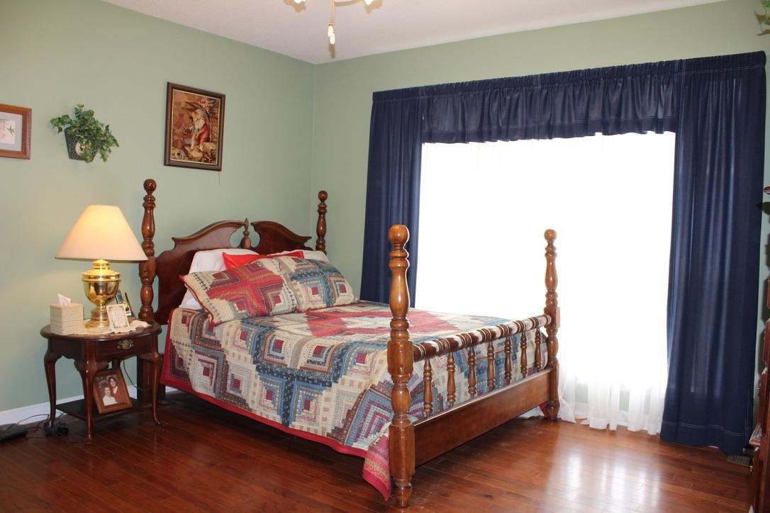 954 New Hope Road Ripley, TN 38063 - Photo 13 of 35 a bedroom with a bed and wooden floor